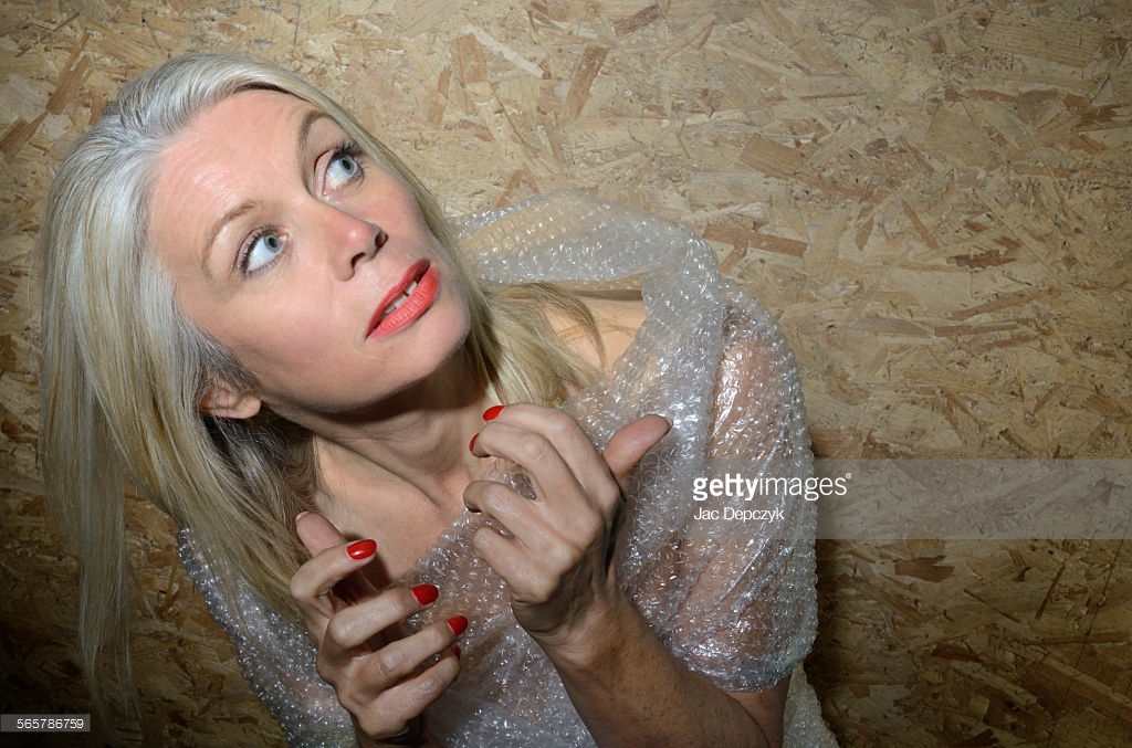 Mature woman anxious bubble wrapped - First photo shoot for Getty Images by Ali Lochhead and Jac Depczyk. https://www.gettyimages.com/license/565786759