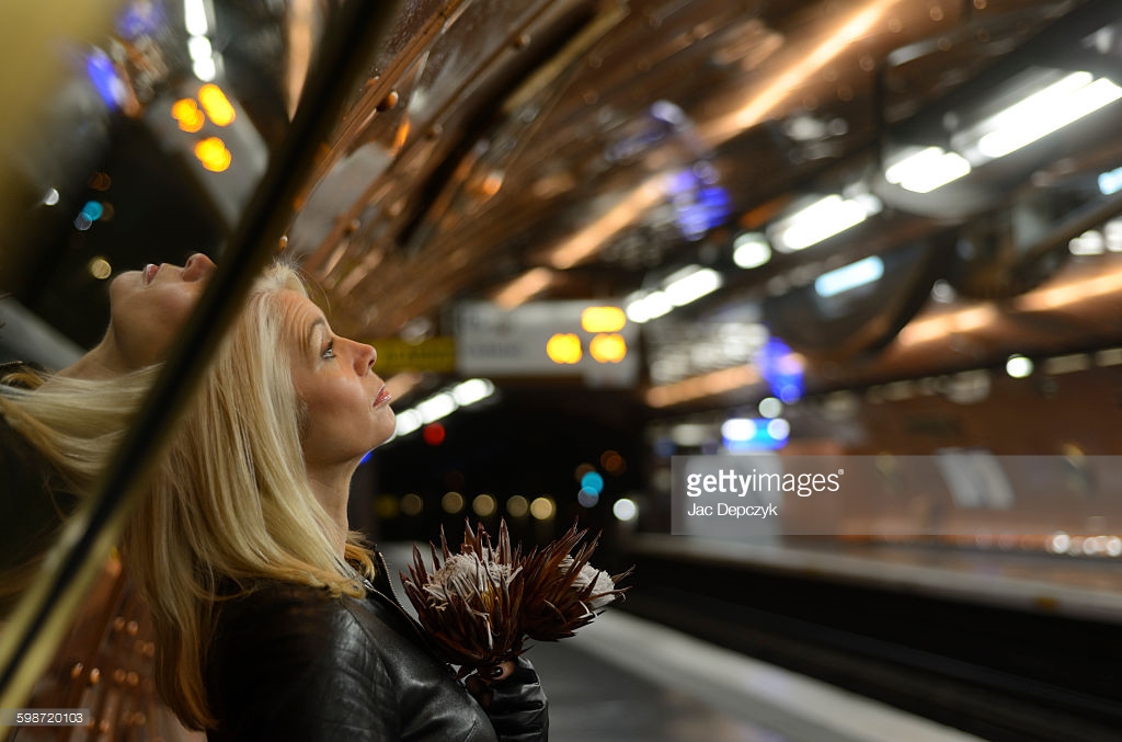 Blonde woman thinks deeply at empty metro station. Photo shoot for Getty Images - Ali Lochhead shot by Jac Depczyk in Paris. https://www.gettyimages.com/license/598720103