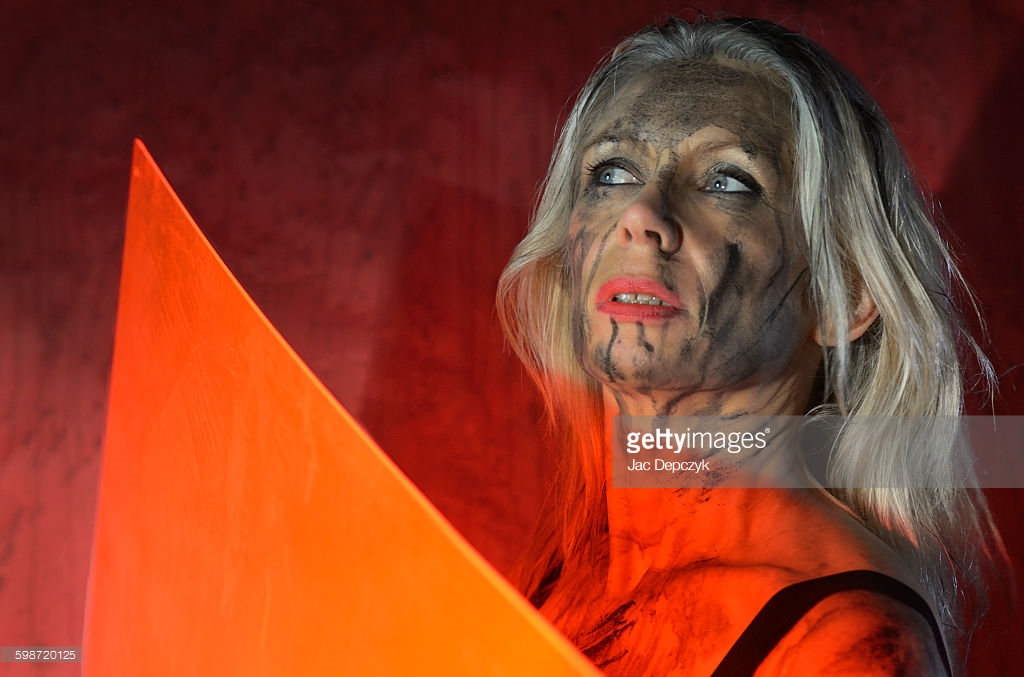She's scared they'll strike again, not sure what the next blow will bring. Painted woman using plastic as shield. Photo shoot for Getty Images - Ali Lochhead shot by Jac Depczyk in London. https://www.gettyimages.com/license/598720125