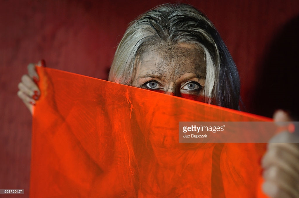 Photo shoot for Getty Images - Ali Lochhead in black camouflage paint with red perspex shield shot by Jac Depczyk in London. https://www.gettyimages.es/license/598720127